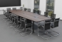 ELLA480i dark with 3 induction charging surfaces and conference chairs in the room